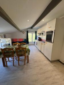 a kitchen and dining room with a table and chairs at appartement 2 bord de mer in Farinole +8 photos