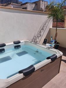 a hot tub sitting on top of a building at Borgo La Chiusa in Cinisi