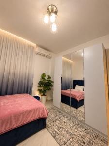 a bedroom with two beds and a mirror at Stunning view in Madinaty in Madinaty +17 photos