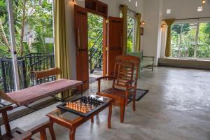 a room with chairs and a chess board on a table at Everdew Kandy in Kandy