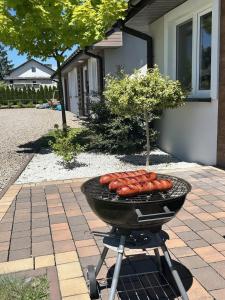 a grill with a bunch of hot dogs on it at Calm Village in Zator