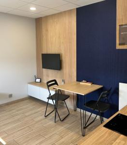 a conference room with a table and chairs and a tv at Calm Village in Zator