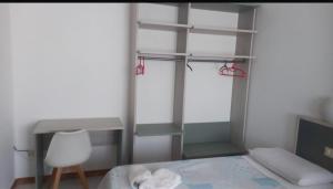 a bedroom with a bed and a desk and a chair at La Voglia in Villanova sullʼArda