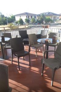 a group of chairs and tables on a patio at La Voglia in Villanova sullʼArda