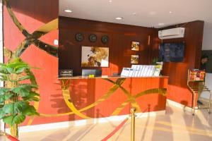 a lobby with a red wall with clocks on it at روعة نجد المغرزات in Riyadh