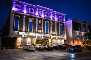 a building with purple lights on the front of it at روعة نجد المغرزات in Riyadh