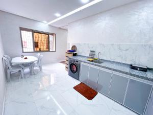 a kitchen with a sink and a table at Apartment in Azemmour in Azemmour