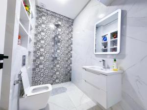 a white bathroom with a shower and a toilet at Apartment in Azemmour in Azemmour +34 photos