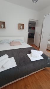 a bedroom with a bed with two white towels on it at Apartman Sarah in Kastel Novi
