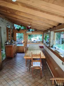 a dining room with a wooden table and chairs at Il Seccatoio in Riolunato
