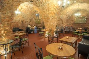 a restaurant with tables and chairs and a brick wall at Soul Rooms Old Town Gdansk in Gdańsk