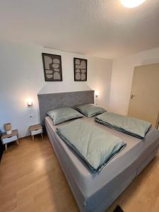 a bedroom with a bed with two pillows on it at Modern Living - Tuttlingen in Tuttlingen