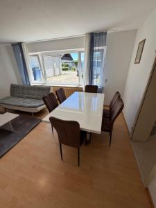 a dining room with a white table and chairs at Modern Living - Tuttlingen in Tuttlingen