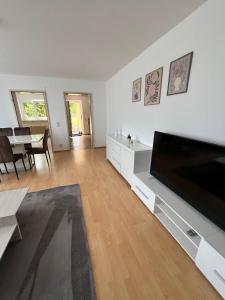 a living room with a large flat screen tv at Modern Living - Tuttlingen in Tuttlingen