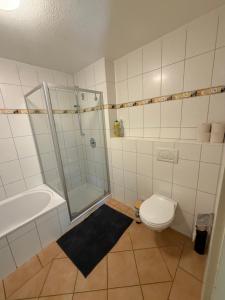 a bathroom with a shower and a toilet at Modern Living - Tuttlingen in Tuttlingen +14 photos