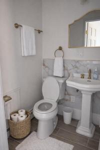 a white bathroom with a toilet and a sink at Sullivan Heritage 1847 - Queen Room Private Bathroom in A Private Home in Boston