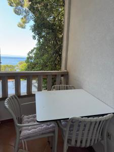 a white table and two chairs on a balcony at Villa BOSE in Brela +84 photos