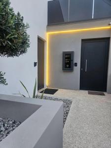 a door with a clock on the side of a building at Sage Villas in Plataria