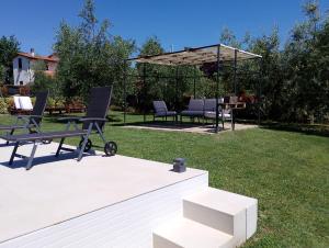 a patio with chairs and a table and a gazebo at Il Piccolo Oliveto in Arezzo