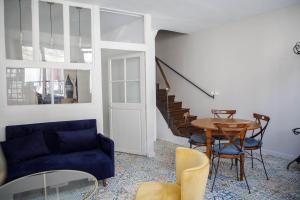 a living room with a blue couch and a table at L' Accointance in Semur-en-Auxois