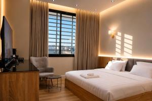 a bedroom with a bed and a chair and a window at Abha Elite Suites ابها ايليت سويتس in Abha +12 photos