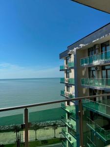 a view of the ocean from the balcony of a building at The Fresh Wave hotel in Batumi