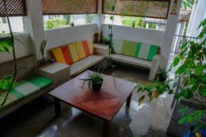 a living room with a couch and a table at Everdew Kandy in Kandy +113 photos