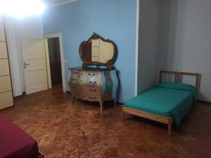 a bedroom with a dresser and a mirror and a bed at Casa Regina in Dongo