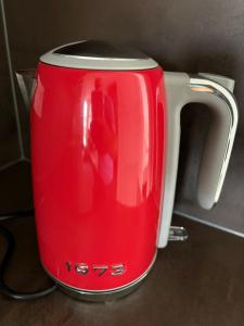 a red and white toaster sitting on a counter at Cozy Apartment in Graz