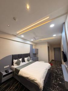 a bedroom with a large bed in a room at Hotel J K Town in Ahmedabad
