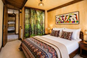a bedroom with a large bed and a window at Apartamentos El Guardaviñas in Ábalos