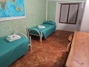 a room with two beds and a table at Casa Regina in Dongo
