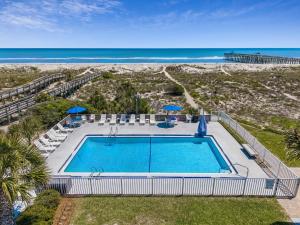 an overhead view of a swimming pool and the beach at Beachside Motel - Amelia Island in Amelia Island