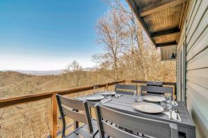 a table and chairs on a balcony with a view at Calling Me Home in Lenoir