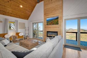 a living room with a couch and a fireplace at Calling Me Home in Lenoir +41 photos