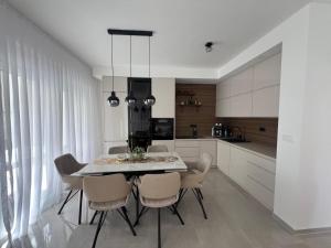 a kitchen with a table and chairs in a room at Guest House Gabi in Srima