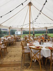 a marquee set up for a wedding with tables and chairs at B&B Het Doctershoes in Kinrooi