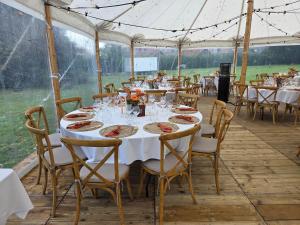 a table set up for a wedding in a marquee at B&B Het Doctershoes in Kinrooi +113 photos