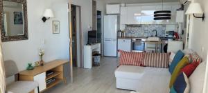 a living room with a couch and a kitchen at Costa Plana apartment with terrace and sea view in Cap d'Ail