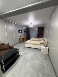 a bedroom with a bed and a tv in it at Park Avenue Kobuleti in Kobuleti
