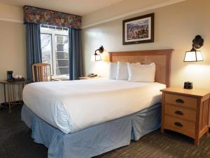 a hotel room with a large bed and a window at El Tovar - Inside the Park in Grand Canyon Village