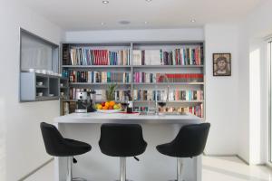 a kitchen with a large book shelf with books at Organic Gardens Villa in Crikvenica
