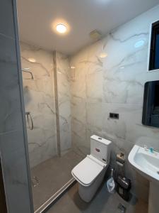a bathroom with a toilet and a sink at Park Avenue Kobuleti in Kobuleti +20 photos