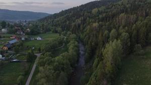 an aerial view of a river in a forest at Domek Beskid Żywiecki in Rycerka Dolna +3 photos