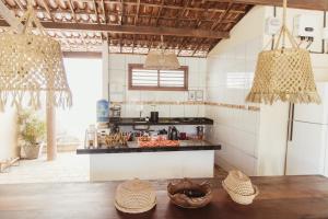 a kitchen with a stove and a counter with baskets at CASA DA PIPA in Pipa