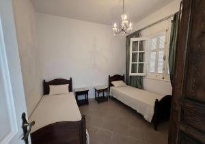 a room with two beds and a chandelier at Antique seaside appartement in Mahdia