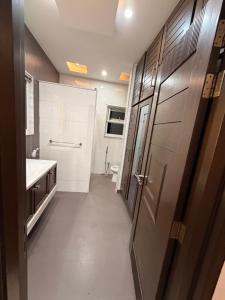 a bathroom with a toilet sink and a door at Private villa in Lahore