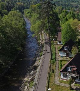 a view of a river with houses and a road at Domek Beskid Żywiecki in Rycerka Dolna