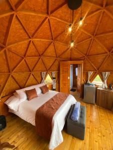 a bedroom with a large bed in a tent at Domos lago Muisca Xue in Aquitania