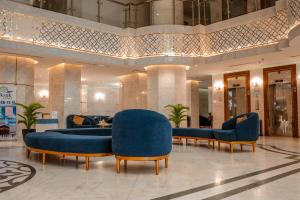 a lobby with blue furniture in a building at فندق الكنارى ان in Mecca